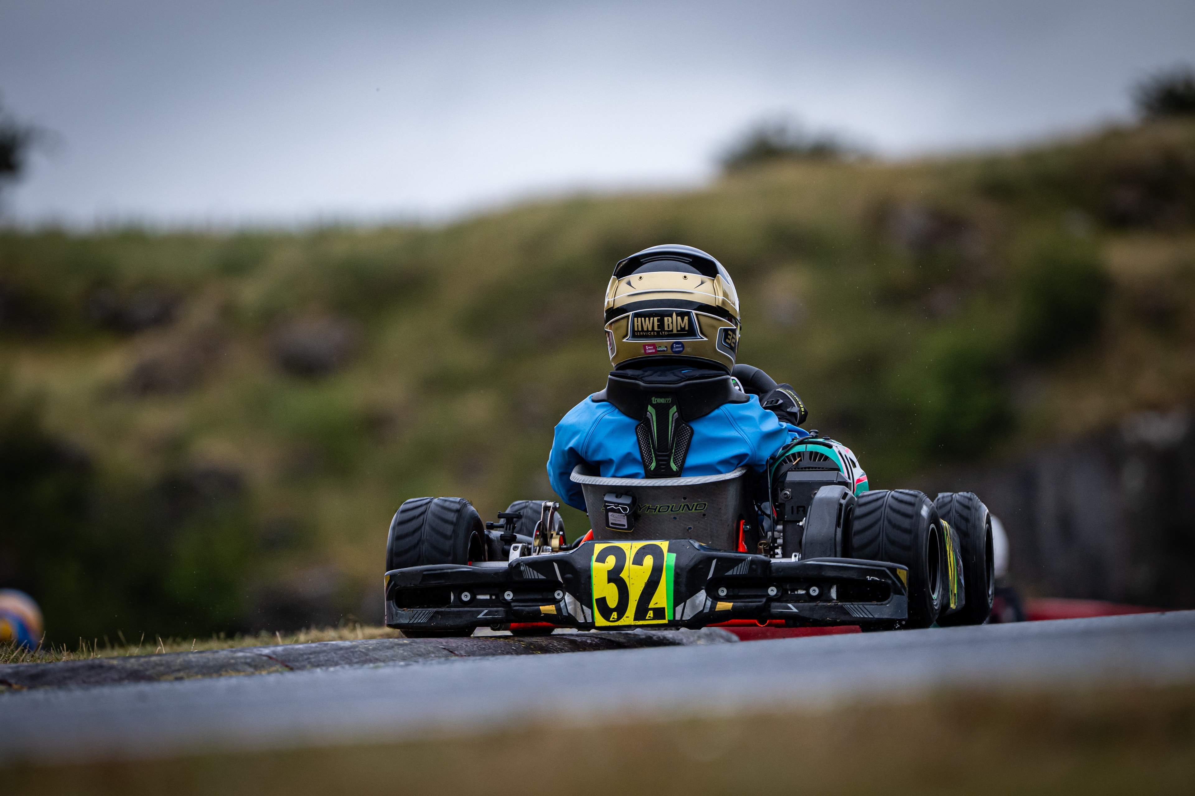 Henry Exton kart number 32 from behind leading at Rowrah with HWE BIM helmet