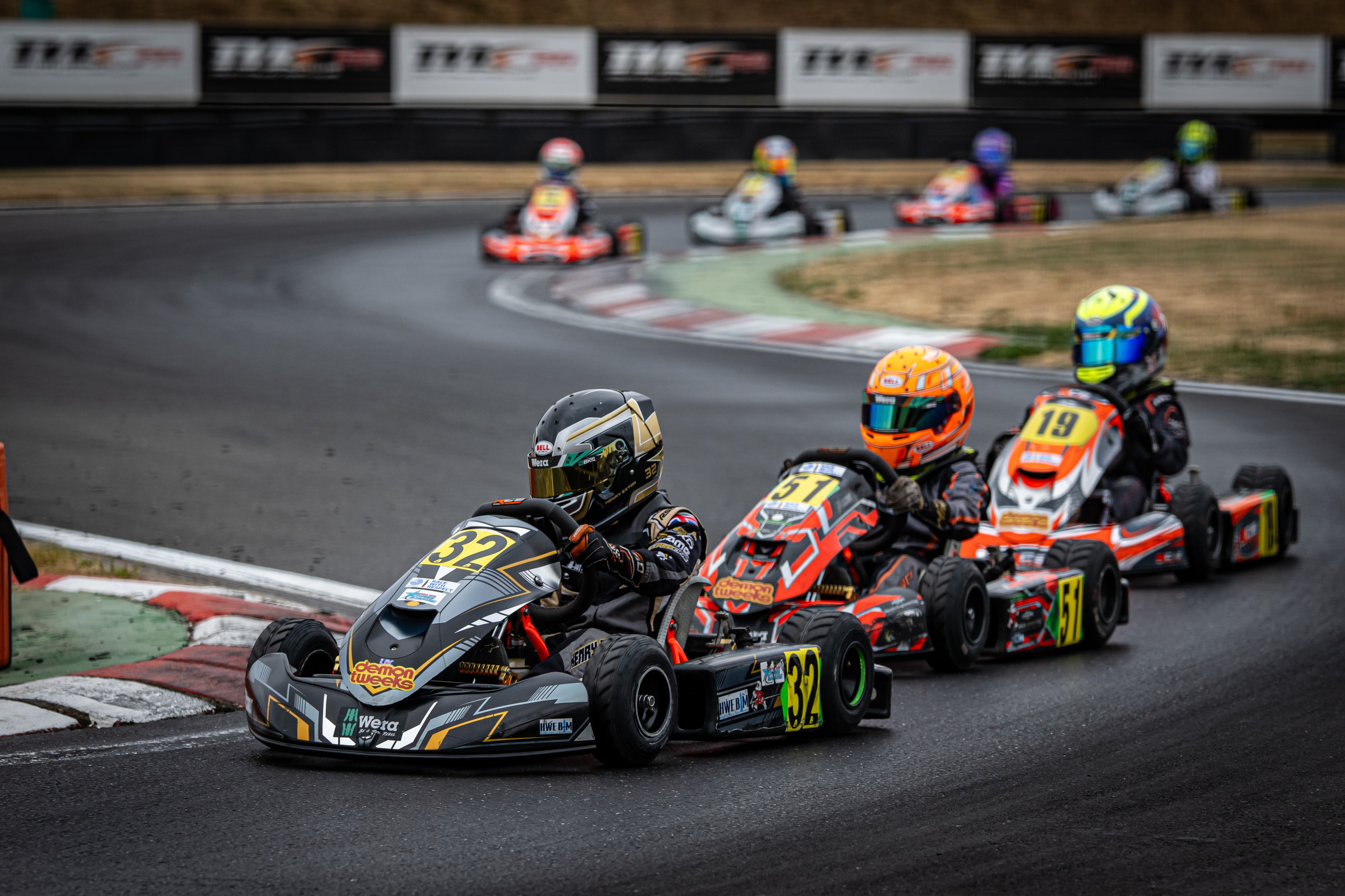 Henry Exton kart number 32 leading pack through corner at PFI