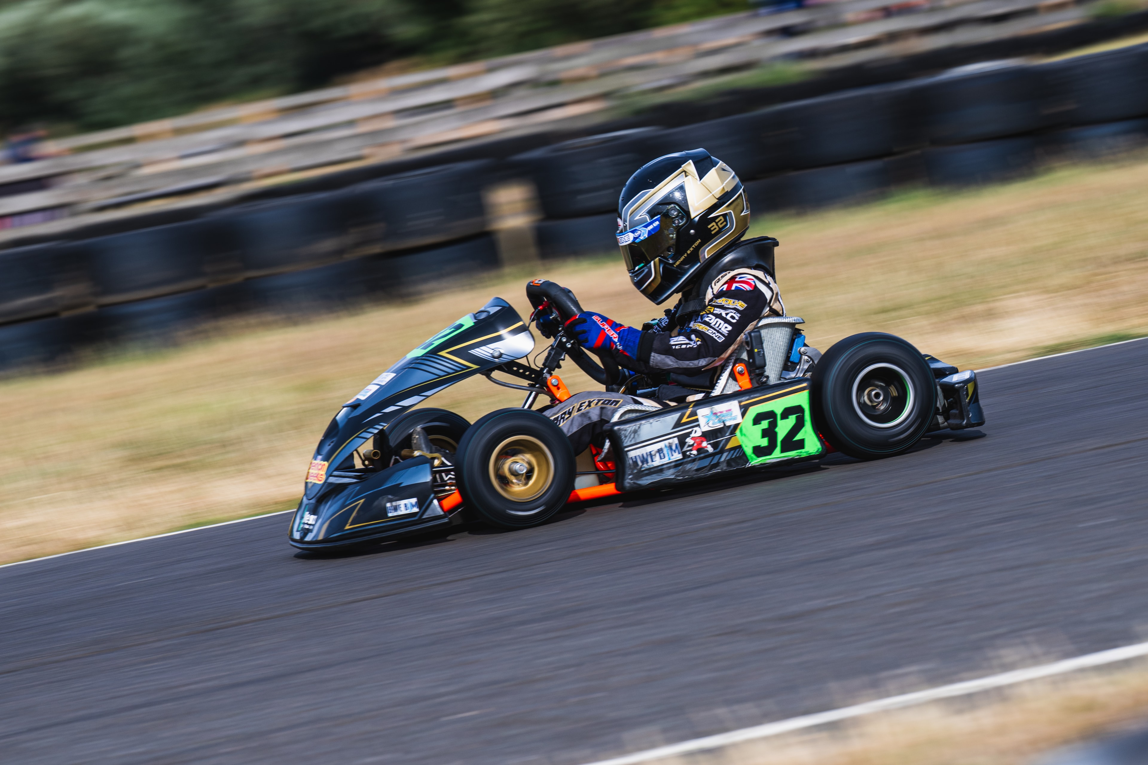 Henry Exton kart number 32 solo on track with motion blur at Whilton Mill